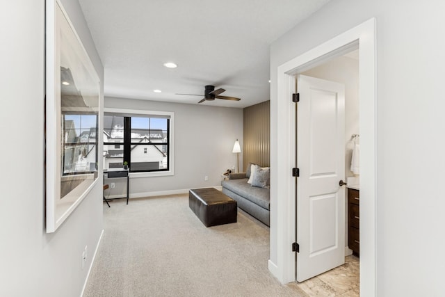 carpeted living room with ceiling fan