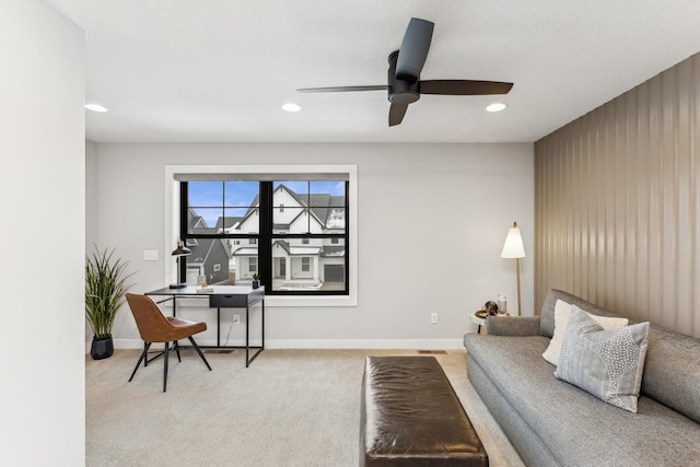 carpeted living room with ceiling fan