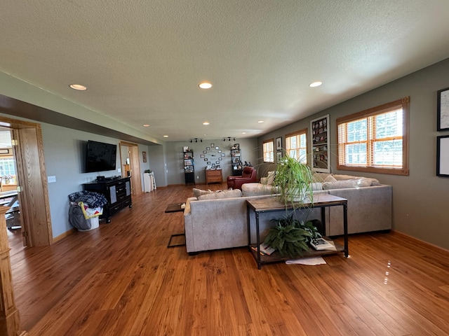 310 7th St SW, Roseau, MN 56751 - living room with a textured ceiling, hardwood / wood-style flooring, recessed lighting, and baseboards