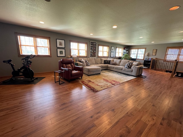 310 7th St SW, Roseau, MN 56751 - living area with baseboards, recessed lighting, hardwood / wood-style flooring, and a textured ceiling