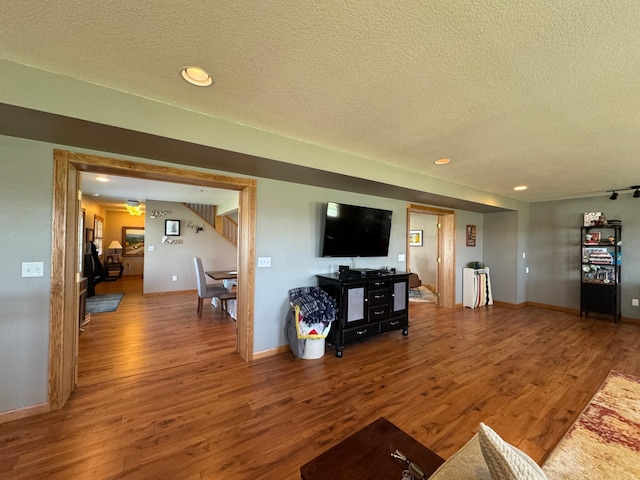 310 7th St SW, Roseau, MN 56751 - living area featuring recessed lighting, a textured ceiling, wood finished floors, and baseboards