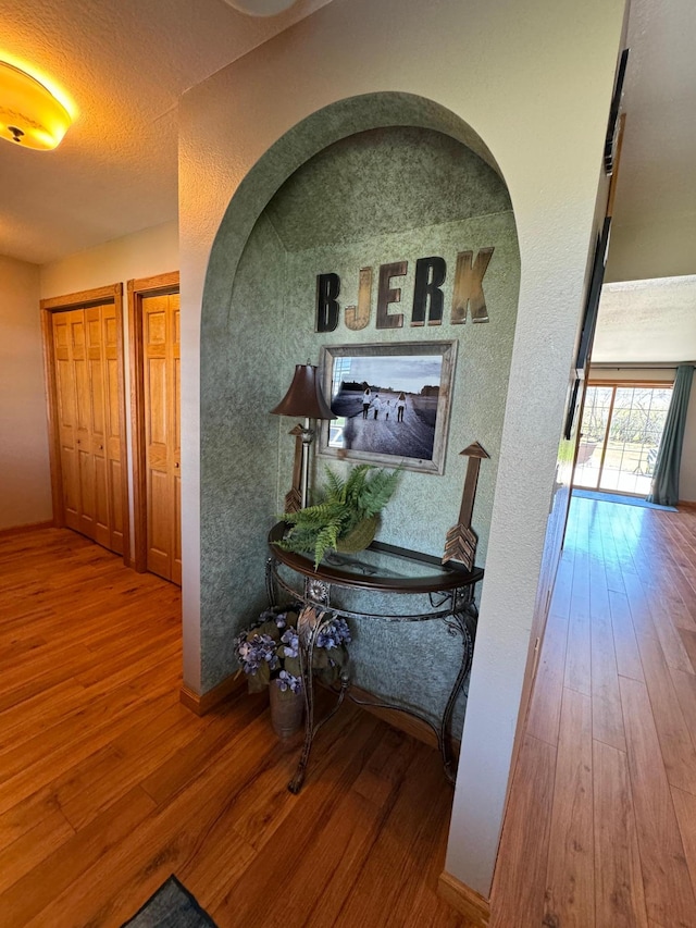 310 7th St SW, Roseau, MN 56751 - hall featuring a textured wall, baseboards, and wood-type flooring