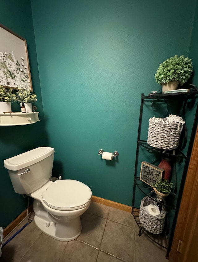 310 7th St SW, Roseau, MN 56751 - bathroom with toilet, tile patterned flooring, and baseboards