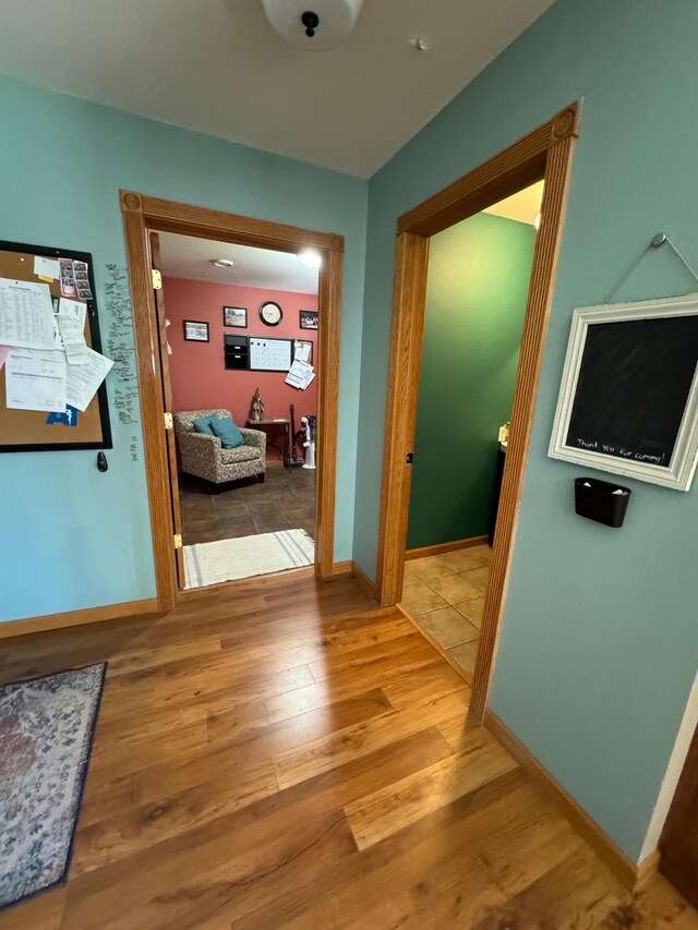 310 7th St SW, Roseau, MN 56751 - hallway with baseboards and wood finished floors