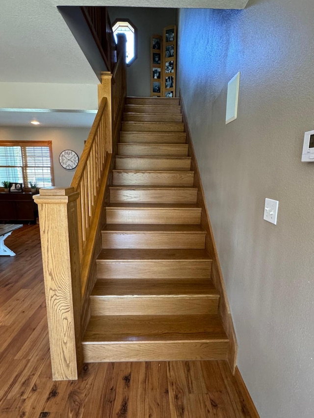 310 7th St SW, Roseau, MN 56751 - stairway with wood finished floors and baseboards