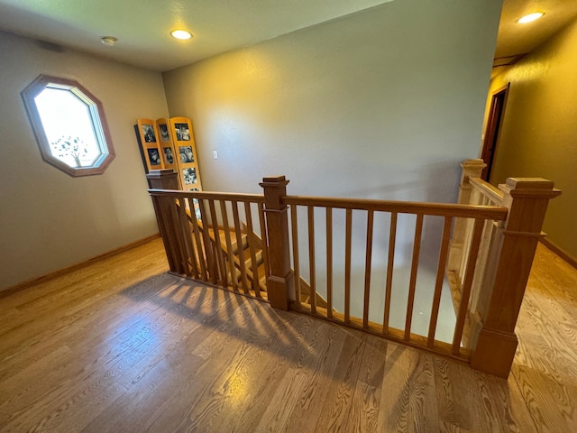 310 7th St SW, Roseau, MN 56751 - staircase with recessed lighting, wood finished floors, and baseboards