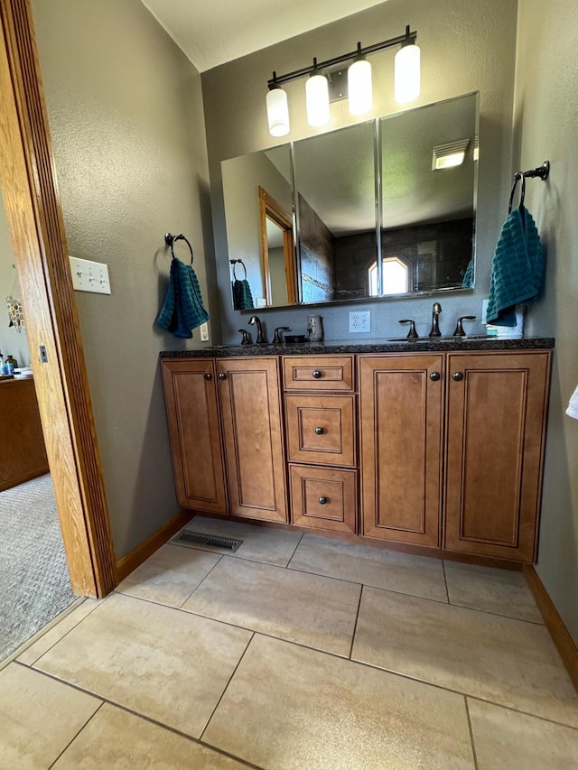 310 7th St SW, Roseau, MN 56751 - bathroom with double vanity, a textured wall, tile patterned floors, and a sink