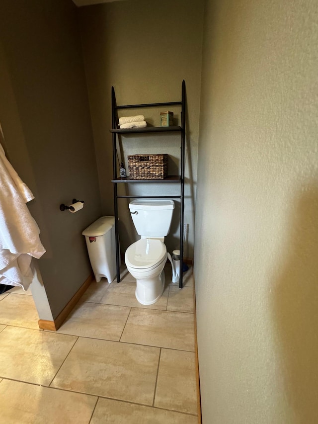 310 7th St SW, Roseau, MN 56751 - bathroom with a textured wall, toilet, tile patterned flooring, and baseboards