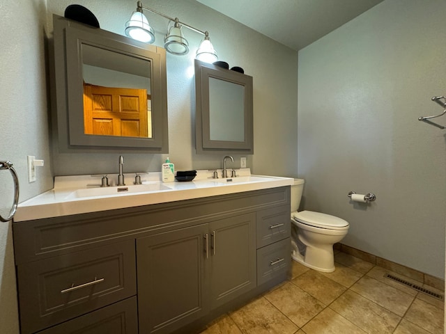 310 7th St SW, Roseau, MN 56751 - bathroom with toilet, tile patterned flooring, a sink, and visible vents