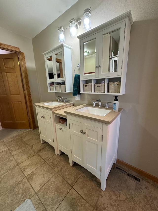310 7th St SW, Roseau, MN 56751 - bathroom with tile patterned floors, visible vents, and vanity