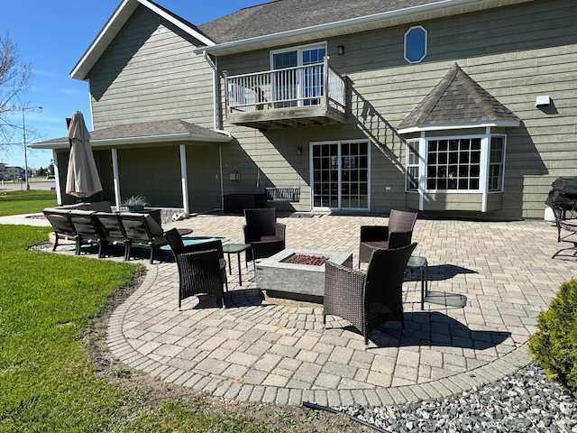 310 7th St SW, Roseau, MN 56751 - rear view of property featuring a lawn, a balcony, and a patio area