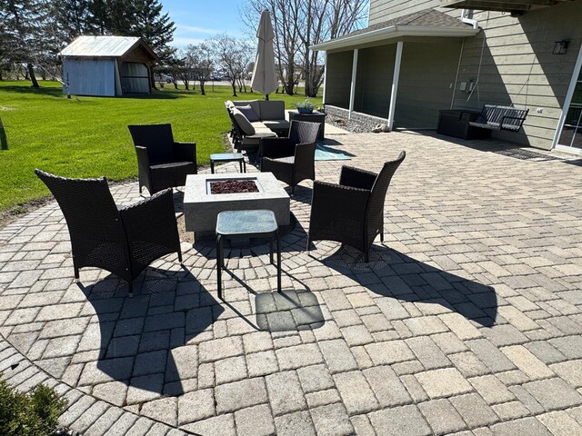 310 7th St SW, Roseau, MN 56751 - view of patio featuring an outdoor structure and an outdoor living space with a fire pit