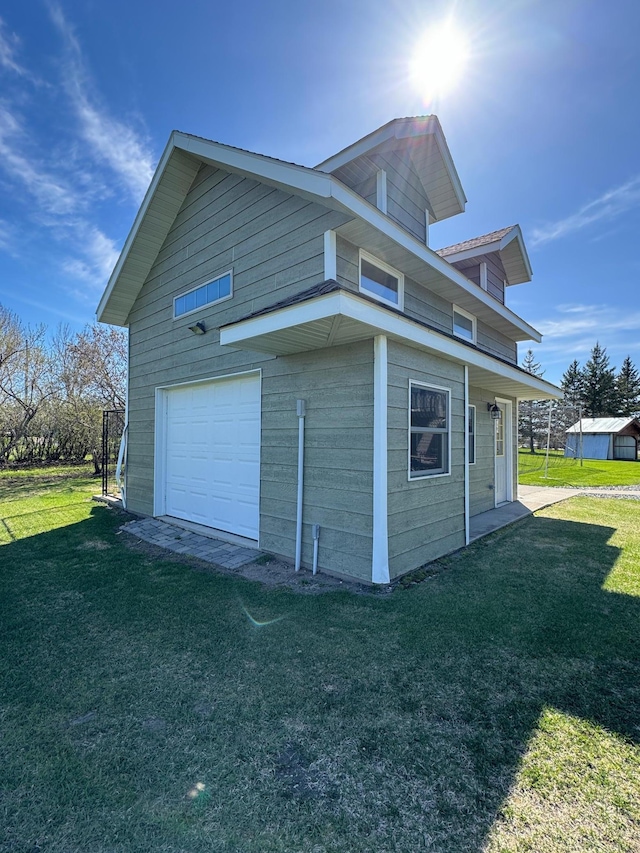 310 7th St SW, Roseau, MN 56751 - view of side of home featuring a lawn and an outbuilding
