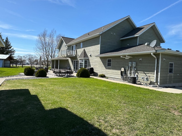 310 7th St SW, Roseau, MN 56751 - rear view of property with a lawn, a patio area, and a balcony
