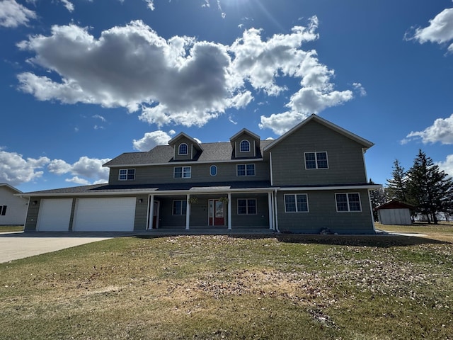 310 7th St SW, Roseau, MN 56751 - view of front of property with driveway, covered porch, a front yard, and an attached garage