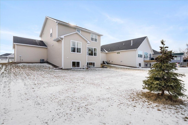 snow covered house with central AC unit