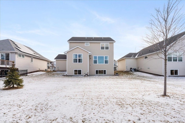 view of snow covered back of property