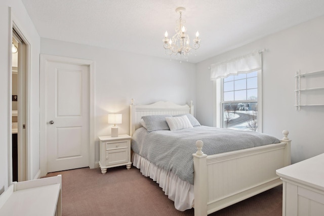 bedroom with a chandelier and dark colored carpet