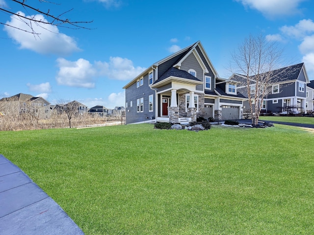 view of front facade with a garage, a residential view, and a front yard