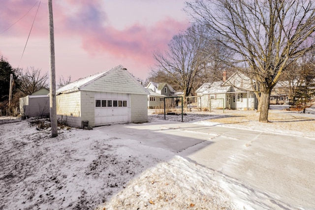 view of garage at dusk