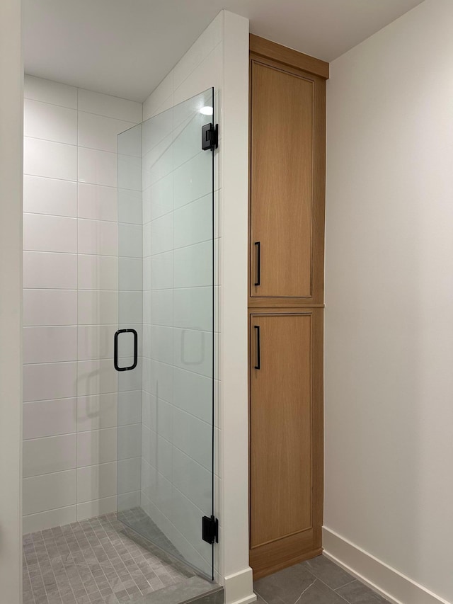 bathroom with tile patterned floors and walk in shower