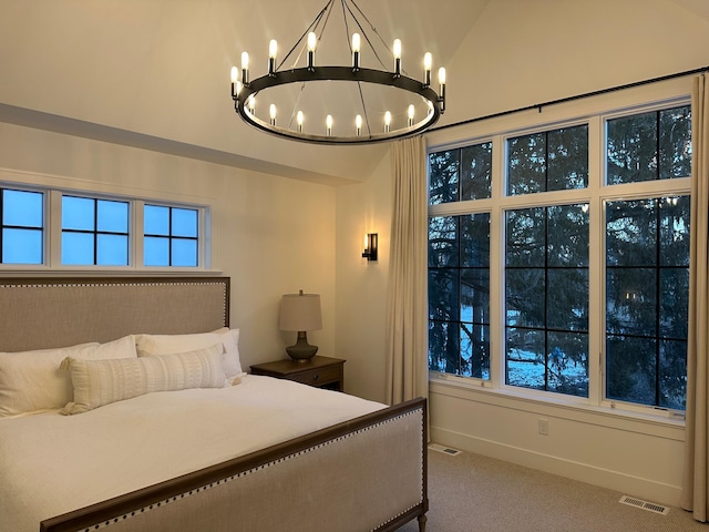 carpeted bedroom featuring vaulted ceiling and a chandelier