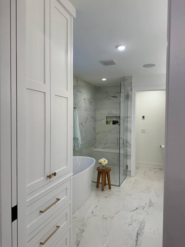 bathroom featuring shower with separate bathtub