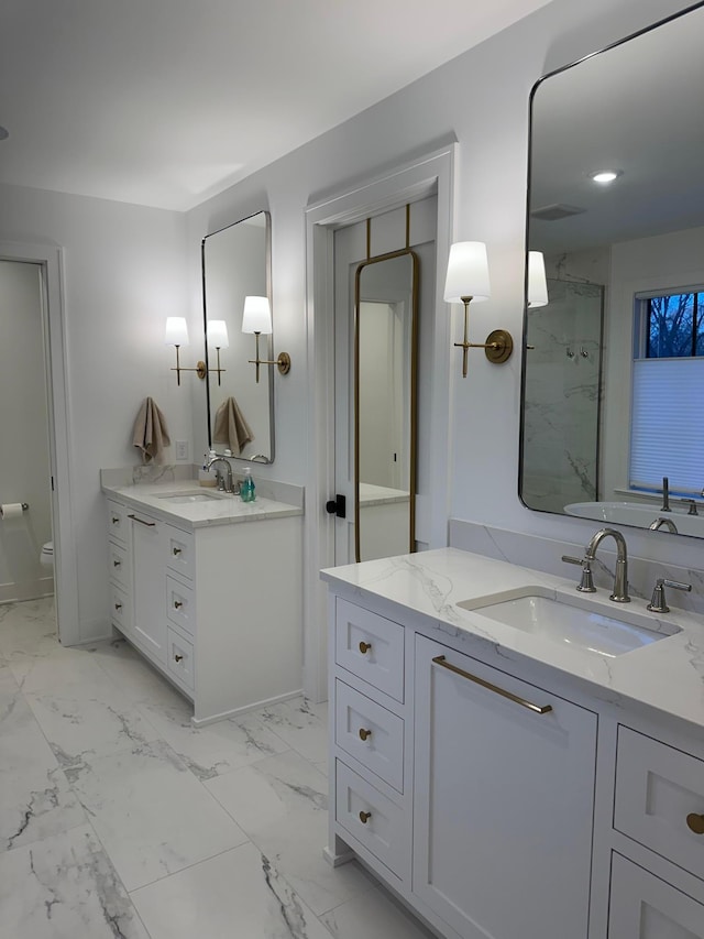 bathroom with vanity, toilet, and a shower