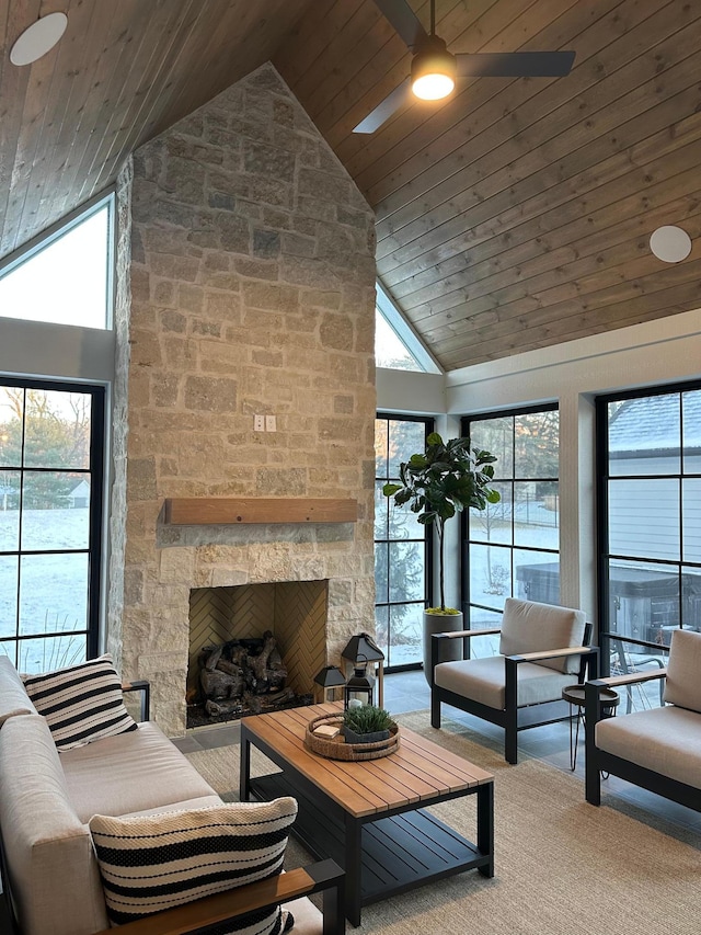 living room featuring carpet flooring, high vaulted ceiling, a stone fireplace, and wooden ceiling