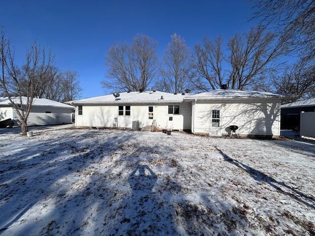 view of snow covered rear of property