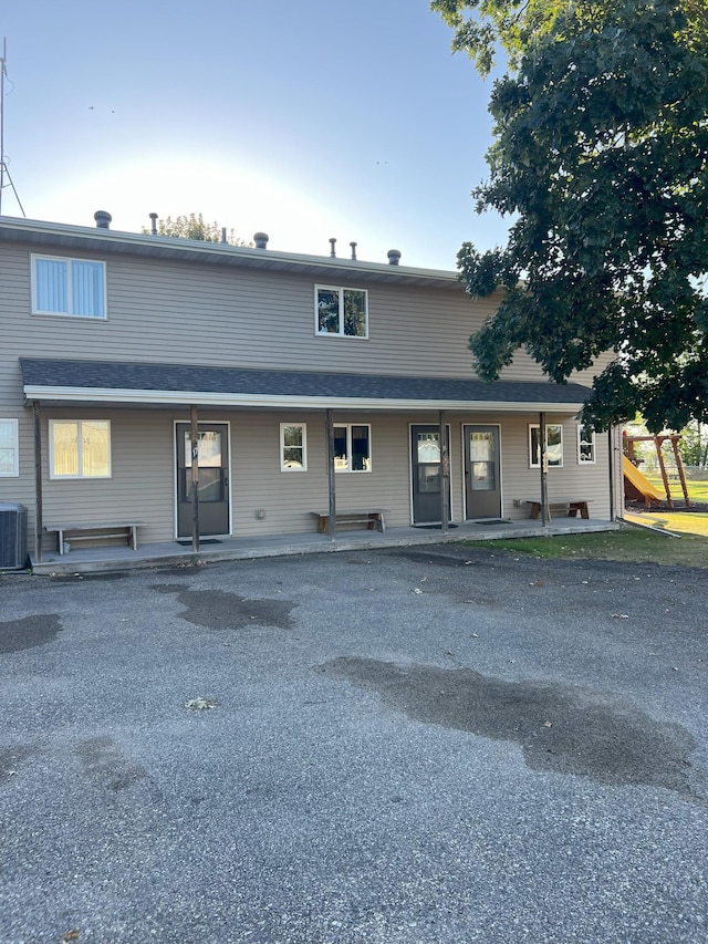 view of front of home with a patio area and central AC