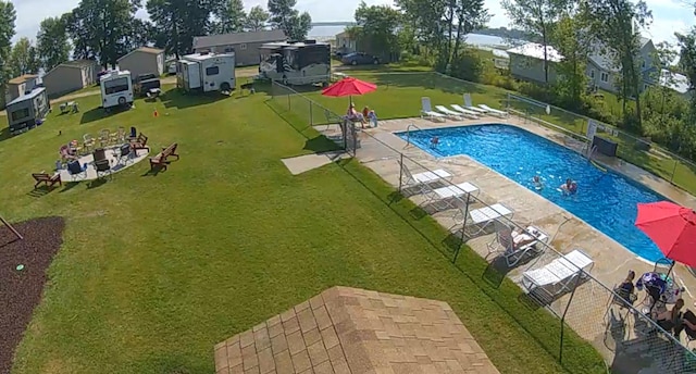 view of swimming pool with a yard and a patio area