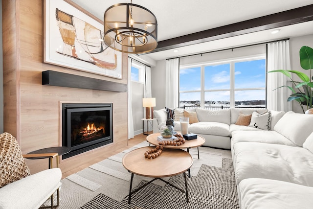 living room with light wood-type flooring and an inviting chandelier