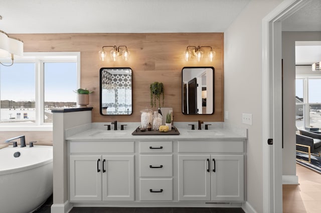 bathroom with a tub to relax in and vanity