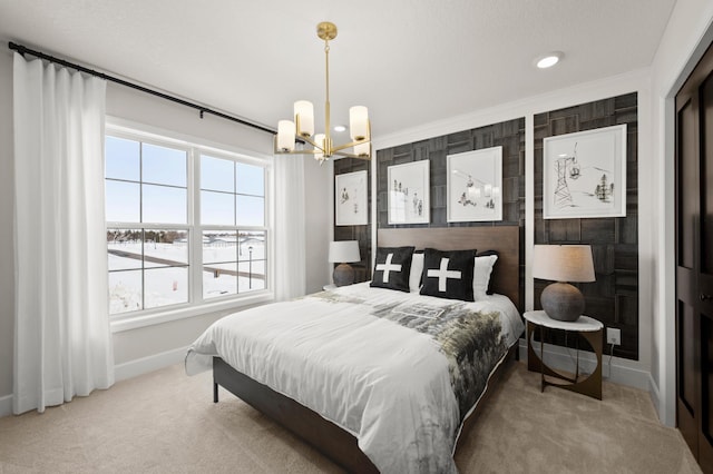 bedroom featuring an inviting chandelier, ornamental molding, and carpet flooring