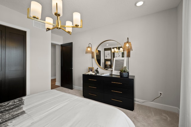 carpeted bedroom with a notable chandelier