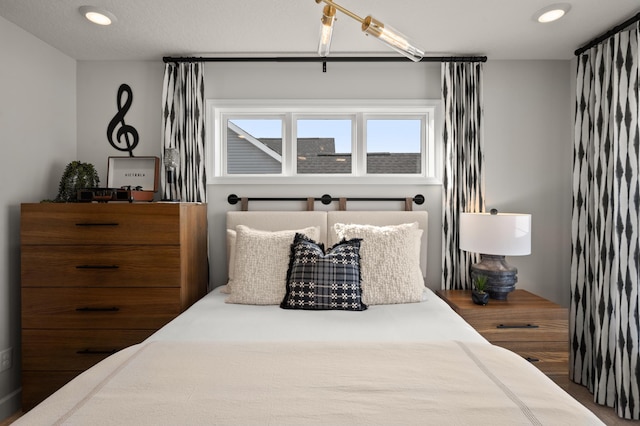 bedroom featuring dark hardwood / wood-style flooring and an inviting chandelier