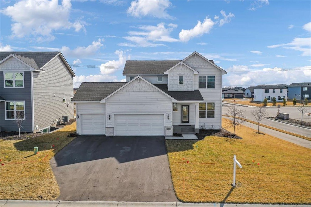 view of front of home with a front lawn and a garage