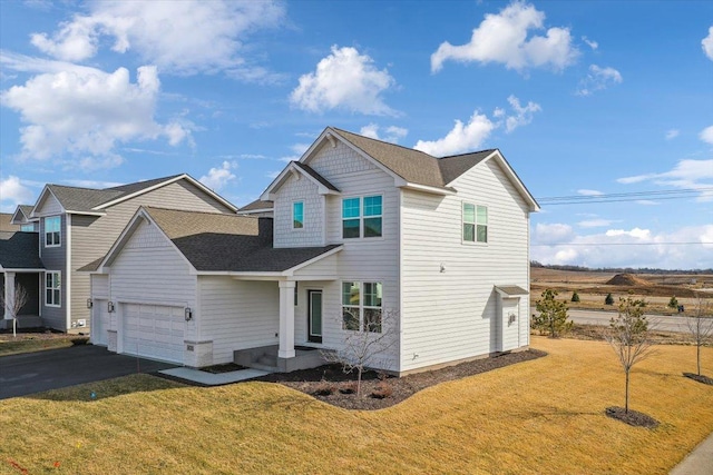 view of front of home with a front yard and a garage