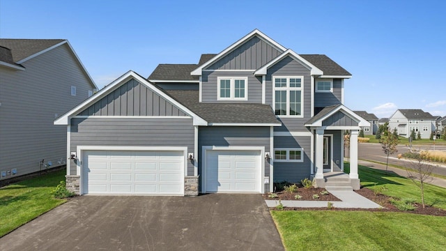 craftsman-style house featuring a front lawn and a garage