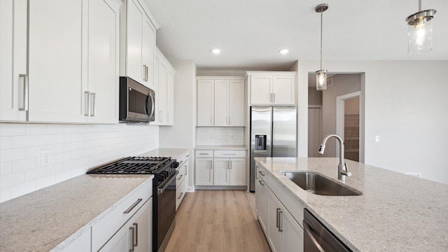 kitchen featuring white cabinets, sink, and stainless steel appliances