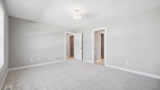 empty room featuring light colored carpet