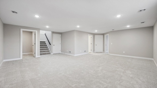 basement featuring light colored carpet