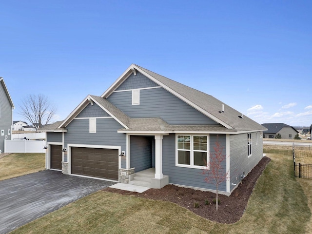 view of front facade with a garage and a front lawn