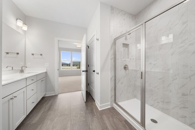 bathroom featuring vanity and an enclosed shower