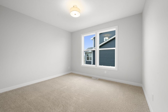 unfurnished room featuring carpet