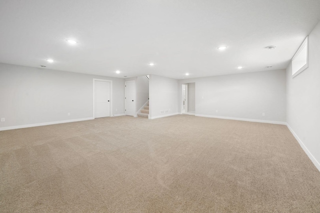 basement featuring light carpet