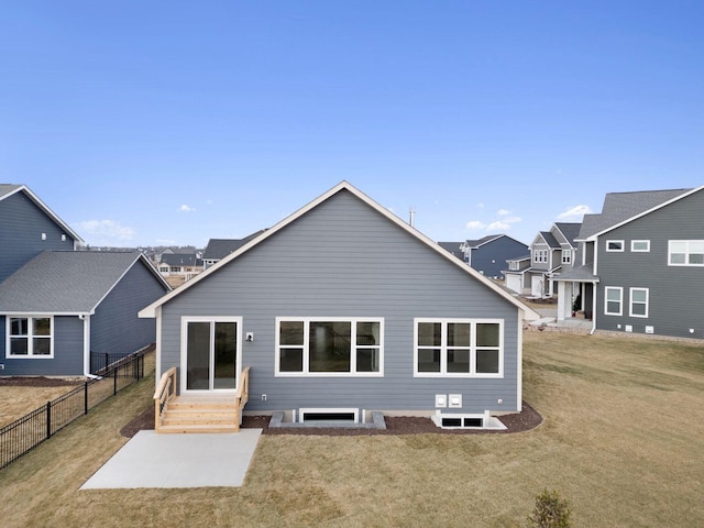 rear view of house featuring a lawn