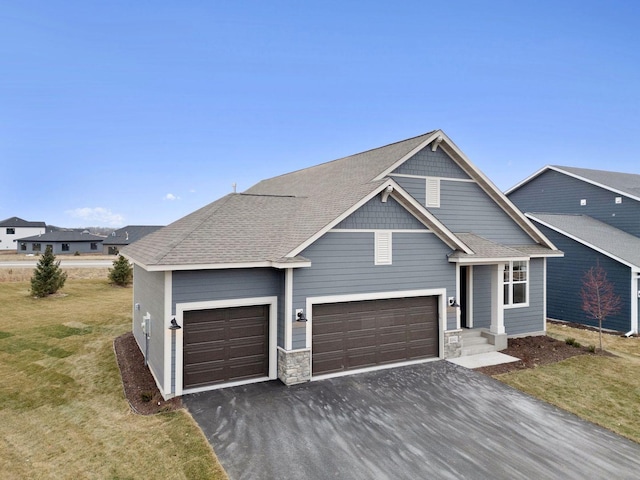 10142 Arrowwood Trl, Woodbury, MN 55129 - view of front of home featuring driveway, an attached garage, a front lawn, and stone siding