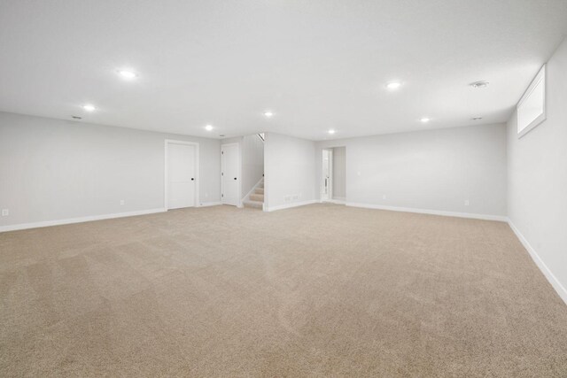 10142 Arrowwood Trl, Woodbury, MN 55129 - finished below grade area with recessed lighting, stairway, light colored carpet, and baseboards